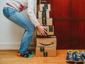 Woman lifting heavy Amazon Prime boxes during Prime Day offer sa
