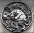 Lion and snake. Stone relief at the building of the Faculte de Medicine Paris.