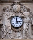 Two muses support the clock, topped by the coat of arms of Cardinal Richelieu, Saint Ursule chapel of the Sorbonne in Paris Royalty Free Stock Photo