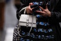 Paris, France - January, 25, 2024: woman wears HM silver glittery handbag, street style