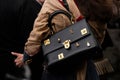 Paris, France - January, 22, 2024: woman wears Schiaparelli large secret Bijoux bag, fashion blogger outfit details