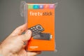 Man holding in hand package with new FireTV Stick