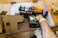 Man hand holding removing from box during unpacking new modern w