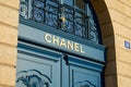 Chanel luxury store sign on blue door in place Vendome in Paris, France