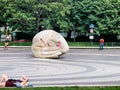 Children crawl on a Listener sculpture