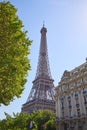Eiffel Tower, Paris building and green tree in a sunny summer day, clear blue sky Royalty Free Stock Photo