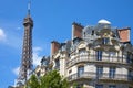 Eiffel Tower top and typical building in Paris with balcony in a sunny day, clear blue sky Royalty Free Stock Photo