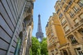 Eiffel Tower and typical street with ancient buildings in Paris in a sunny summer day, clear blue Royalty Free Stock Photo