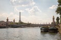 A few barges and Alexander the Third Bridge on the background of the Eiffel Tower in Paris Royalty Free Stock Photo