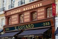 Goyard luxury shop in Paris with wooden facade and golden letters sign in summer