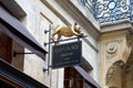 Goyard luxury store in Paris, ancient black sign with golden french bulldog sculpture