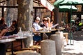 A man is sitting in a coffee shop with other people reading the newspaper Royalty Free Stock Photo