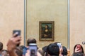 Paris, France - July 6, 2018: Mona Lisa at the Louvre Museum. Tourists photographing the famous picture of Gioconda in Louvre Royalty Free Stock Photo