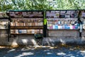 Quai de Montebello, a bouquiniste bookeller station udenr the shadows of the trees. Paris V