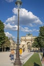 Street Lamp Post and People on the background of the Arc de Triomphe in Place Carrousel in Paris Royalty Free Stock Photo