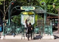 Young tourists at the entrance to the Paris Metropolitain subwa