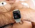 Man setting smartwatch wearing a heart monitor holter
