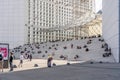 Paris, France - Jun 13, 2020: People with mask on stairs under Grand Arche in afternoon