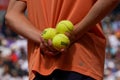 Ball boy holds Wilson Roland Garros tennis ball at Le Stade Roland Garros in Paris, France. Wilson is an Official Partner