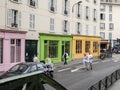 Quai de Valmy city street lined with colourful shopfronts while joggers run along