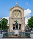 Statue of Jeanne d`Arc with Church of Saint Augustin in the background - Paris