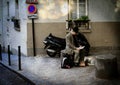 PARIS, FRANCE: June 06, 2013 - a fragment of the street. Parisian sits and reads the news in the local newspaper Paris.