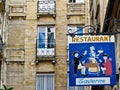 Hand painted hanging sign for restaurant in small alleyway Royalty Free Stock Photo