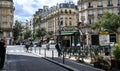 Paris,France.June 2022. In the historic center, a beautiful view of a metro station with a distinctive vintage sign. People on the Royalty Free Stock Photo