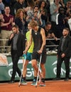 Injured tennis player Alexander Zverev of Germany enters court on crutches after his semi-final match against Rafael Nadal Royalty Free Stock Photo