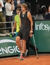 Injured tennis player Alexander Zverev of Germany enters court on crutches after his semi-final match against Rafael Nadal Royalty Free Stock Photo