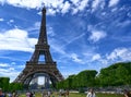 Paris, France, June 2022. In the large gardens of the Champ de Mars people relax in the greenery enjoying the view of the Eiffel