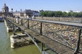 PARIS, FRANCE - JUNE 6., 2013: Lovers have locked thousands of locks to the Pont des Arts bridge in Paris. The padlocks, with keys