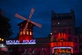 PARIS, FRANCE - JUNE 16, 2016: Moulin Rouge Dancing Cabaret at night in red lights, people crowed. Original Building famous Royalty Free Stock Photo