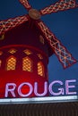 PARIS, FRANCE - JUNE 16, 2016: Moulin Rouge Dancing Cabaret at night in red lights, people crowed. Original Building famous Royalty Free Stock Photo