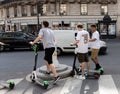 Paris, FRANCE - June 27, 2019: people with Lime electric scooters, rented through a mobile app and dropped off anywhere in the Royalty Free Stock Photo