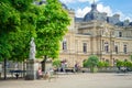 Tourists sit in front of Luxembourg Palace