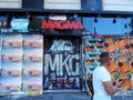 A man passes in front of a closed shop