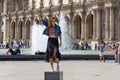 PARIS, FRANCE - JUNE 23, 2017: Unknown young attractive woman standing on the special pedestal and posing for a photo near the