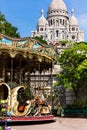 Vintage carousel and Basilica Sacre Coeur on Montmartre Hill. Pa