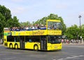 Yellow Tour Bus with Tourists near Eiffel Tower in Paris, France Royalty Free Stock Photo