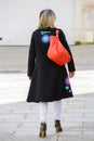 Paris, France - March 27, 2017: Back view of a well dressed blond woman walking on the city streets