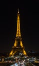 Eiffel Tower brightly illuminated at night in Paris, France