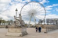 Paris, France, March 28 2017: Ferris wheel - view from Jardin des Tuileries. The giant Ferris wheel Grande Roue is set Royalty Free Stock Photo