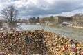 Paris, France - March 13, 2018: Love locks hang on lamp street