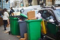 Paris, France - March 12, 2023: Messy streets with overfull garbage bins during binmen strike in Paris, France