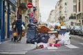 Paris, France - March 12, 2023: Messy streets with overfull garbage bins during binmen strike in Paris, France