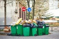 Paris, France - March 16, 2023: Messy streets with overfull garbage bins during binmen strike in Paris, France