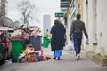 Paris, France - March 12, 2023: Messy streets with overfull garbage bins during binmen strike in Paris, France