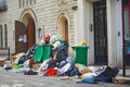 Paris, France - March 16, 2023: Messy streets with overfull garbage bins during binmen strike in Paris, France