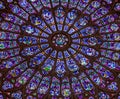 Paris, France, March 27, 2017: Stained glass window at Notre Dame cathedral. Notre Dame church is one of the top tourist Royalty Free Stock Photo